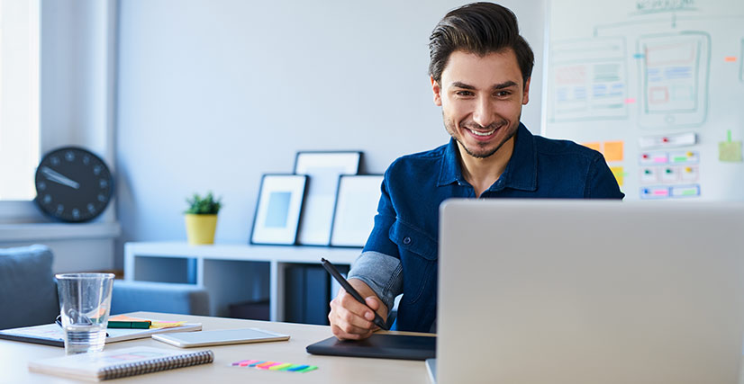 Man looking at laptop working in office