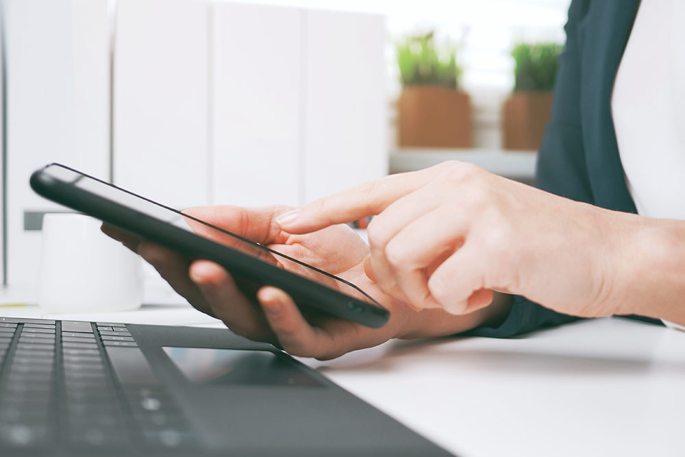 Close up of woman's hand about to click on smartphone screen