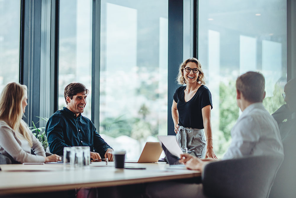 Group of people meeting in conference room smiling and happy